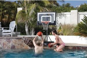 image of a boy and lady playing a basketball in a swimming with a SKLZ adjustable net